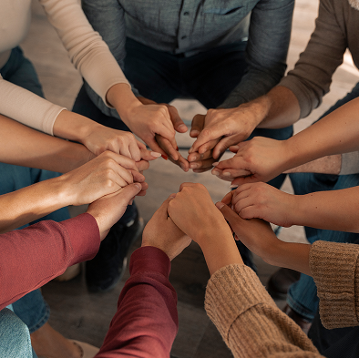 Team of professionals joining hands together representing collaboration and support